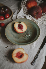 peach and peppercorns on a green plate