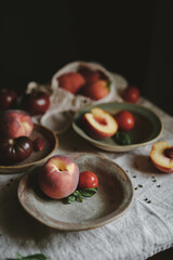 tomatoes and peaches in plates on the table