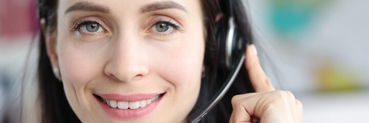 Portrait of woman operator with with headphones answering call