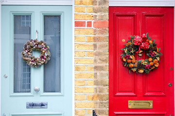 Red and light blue door with a Christmas wreath /...