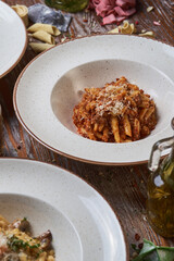 three types of Italian pasta on a wooden table