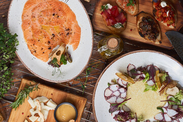 Italian food on the table. Carpaccio, bruschetta, cheese, seafood