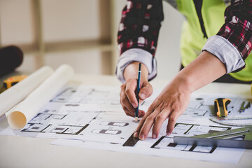 architect concept, working architect with blueprints in office to present to customers