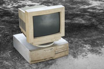 old and obsolete computer set on grunge concrete floor