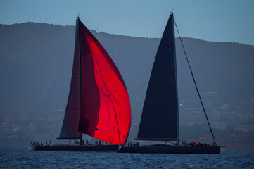 Two sailing yachts in sunset after maxi regatta 