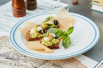 bruschetta on a wooden table in a white plate
