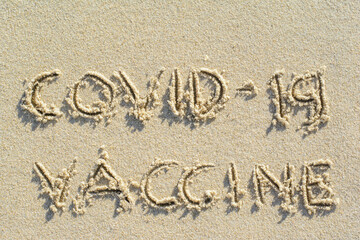 Writing COVID-19 VACCINE word on sand at Samui island the famous place in Thailand on summer with copy space