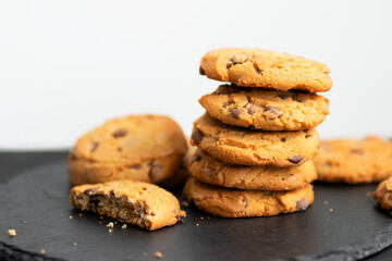 Fresh crispy chocolate cookies on a dark table