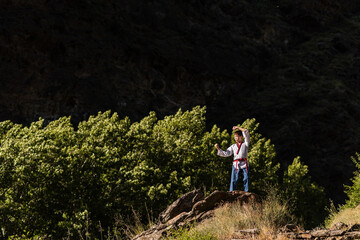 Karate boy practicing his martial arts techniques during training outdoors. Sports concept.