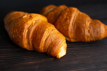 Fresh croissants on dark background