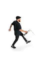 Portrait of stylish bearded man, barber or hair cutter isolated on white studio background. Holding his working equipment.