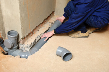 Plumber assemble sewage pipes.