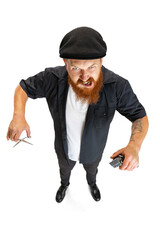 High angle view of red bearded man, barber or hair cutter in black cap isolated on white studio background. Holding his working equipment.