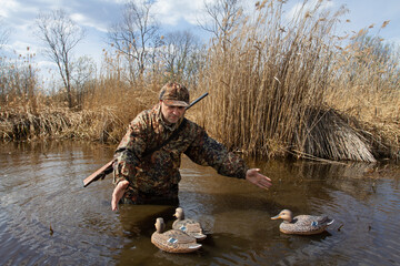 hunter collects plastic bait for ducks from the lake