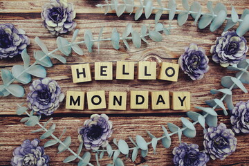 Hello Monday alphabet letter and flower decorate on wooden background