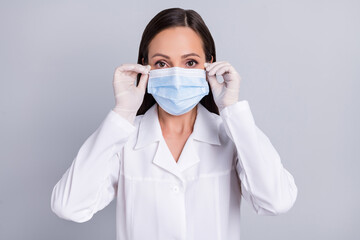 Portrait of attractive skilled doctor wearing mask stop mers cov flu isolated over grey pastel color background