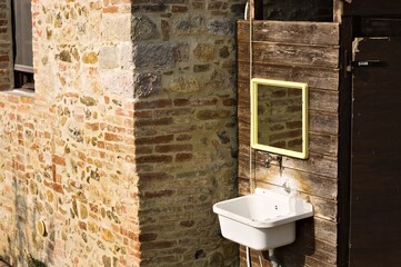 An external sink under a mirror in the garden of a farmhouse in the countryside (Umbria, Italy, Europe)