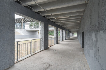 Empty unfinished interior of a modern concrete concrete room with a colonnade.