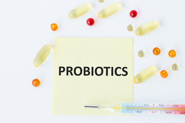 On the card is the inscription PROBIOTICS, around there are blisters with tablets and a thermometer