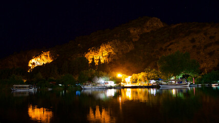Fototapeta premium King rock tombs in the ancient city of Kaunos. Dalyan near Iztuzu beach, which is the spawning area of Caretta Caretta. Caunos and Lycian ancient city. Night view.