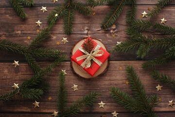 Christmas wooden background with beautiful handmade gift box, top view photography.