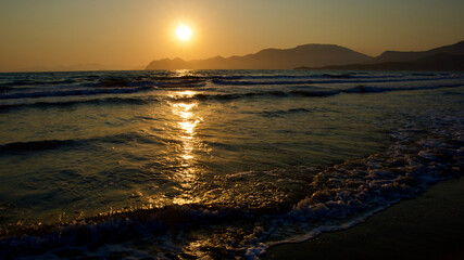 Fototapeta premium Spawning place of Caretta Caretta turtles: Iztuzu beach. Golden sun rays reflecting off the sea at sunset. Spectacular sunset at the meeting point of the Mediterranean and Aegean.