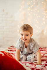 christmas morning. boy sitting on the bed