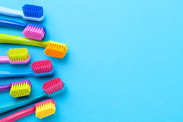 Colorful Toothbrushes On Blue Paper Background