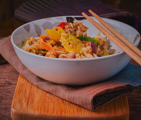 Chicken,rice and vegetables,garnished with herbs and spices.