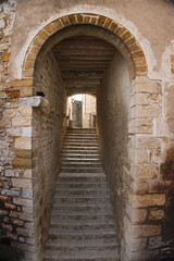 Stairs under an arch in the medieval town of Culla (Castellon, Spain)