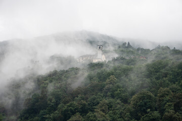 Church in the foggy mountains of italy