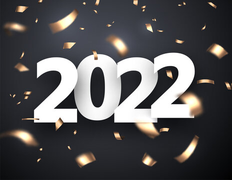 2022 sign with golden foil confetti.