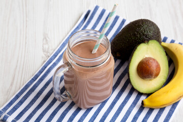 Homemade Chocolate Avocado Smoothie in a Glass Jar Mug, side view.