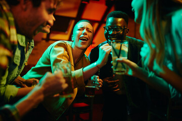 Fototapeta na wymiar Happy African American couple signing karaoke party and having fun in a bar.