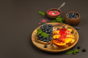 Tasty toast bread with cream cheese and ripe fruits