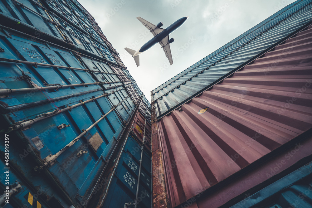 Wall mural freight airplane flying above overseas shipping container . logistics supply chain management and in