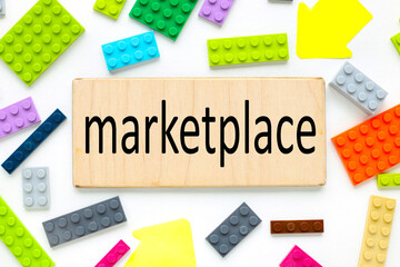 Marketplace. text on a wooden plate near the constructor of different colors
