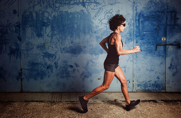 Mature woman running in the street