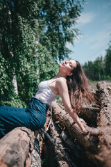 a girl in a beautiful lingerie corset in the forest, magazine photo