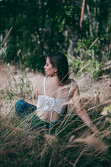 a girl in a beautiful lingerie corset in the forest, magazine photo