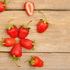 red strawberries on a wooden table .