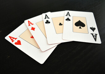 Poker Game Cards - Lucky hand showing four aces - Hearts, Spades, Clubs and Diamonds, symbol of success