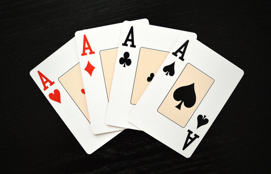Poker Game Cards - Lucky hand showing four aces - Hearts, Spades, Clubs and Diamonds, symbol of success