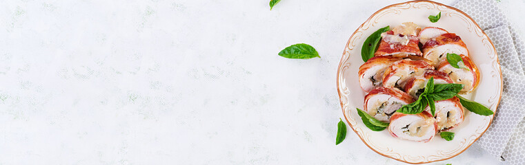 Baked chicken rolls with basil and cheese on  plate. Healthy lunch. Keto diet.Top view, banner, above