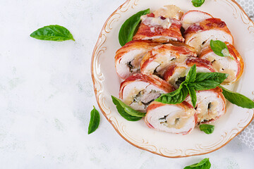 Baked chicken rolls with basil and cheese on  plate. Healthy lunch. Keto diet.Top view, above