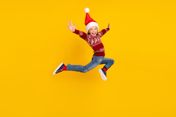 Fototapeta na wymiar Full size photo of amazed excited small girl jump up raise hands season sale isolated on yellow color background