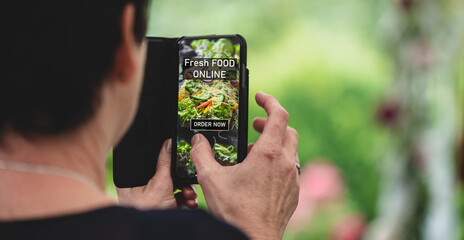 older woman ordering fresh food online by internet