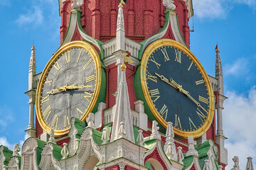 Clock on the Spasskaya tower of the Moscow Kremlin, against the blue sky. Close-up view.