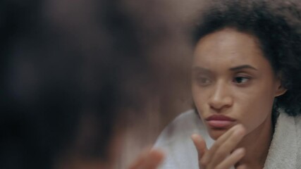 Unhappy woman looking in mirror in the morning, dull skin, lack of vitamins - Powered by Adobe