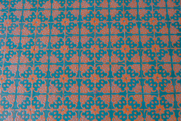 Blue and orange pattern on floor tiles close-up. Top view. Interior design. Tiles background